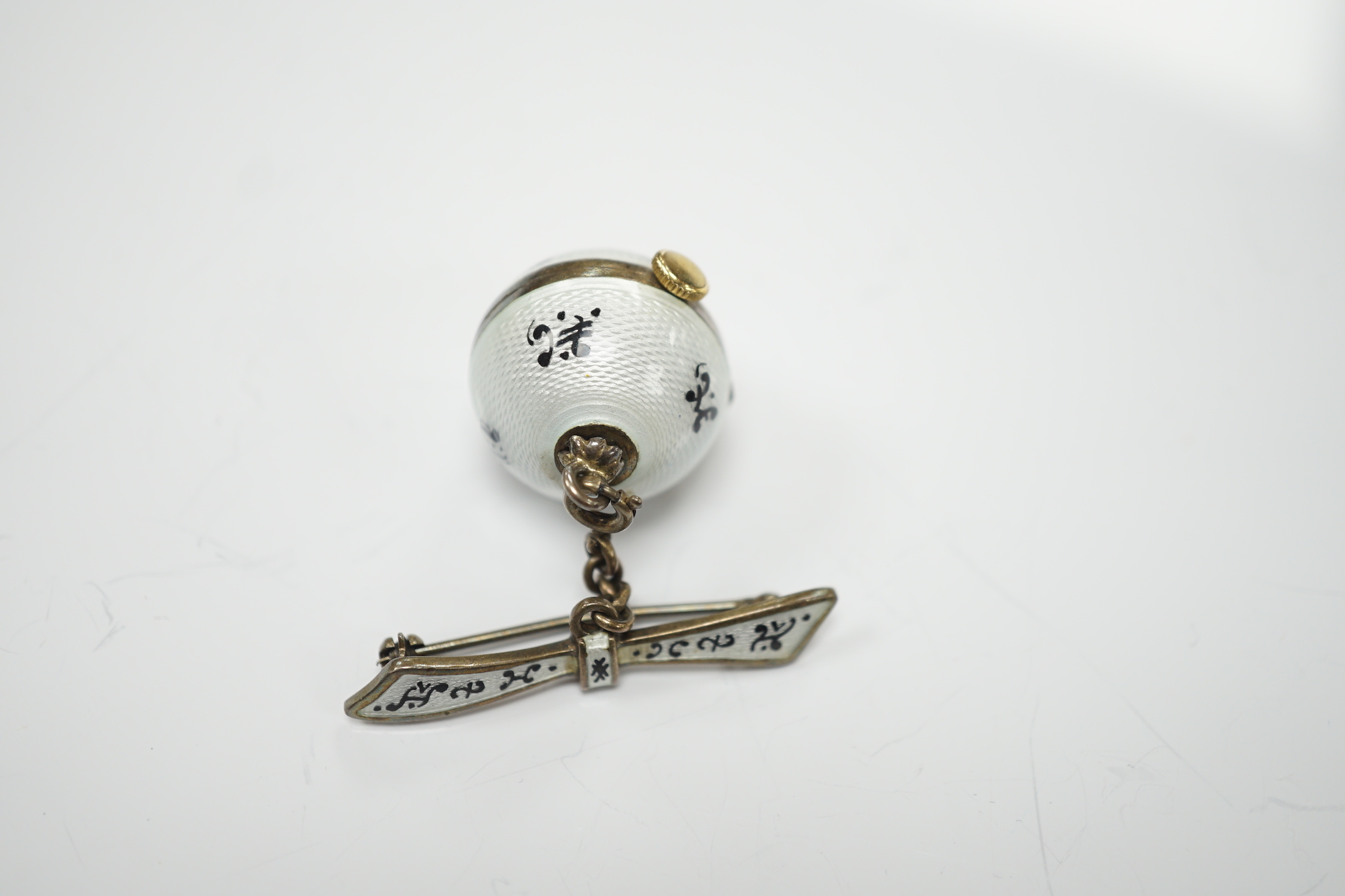 An early to mid 20th century silver and two colour enamel globe pendant watch, on suspension chain with brooch attachment, diameter 20mm.